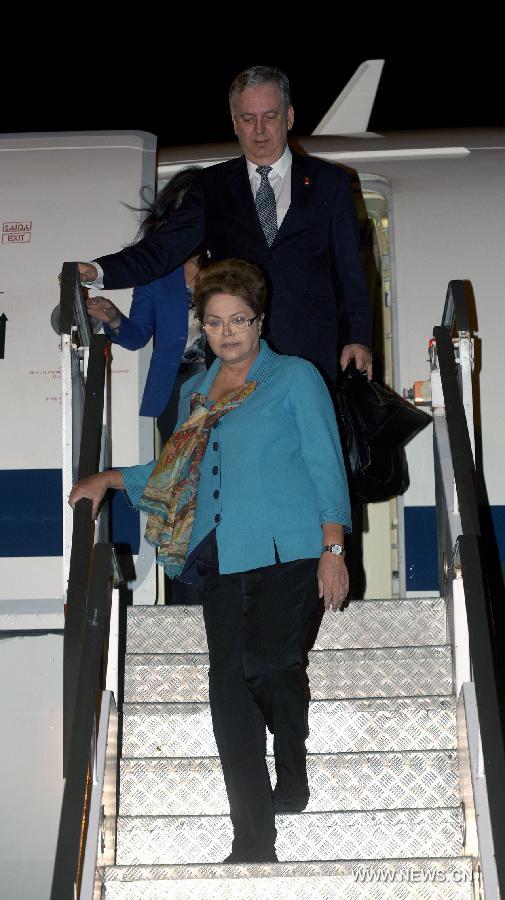 Brazil's President Dilma Rousseff (front) arrives at Brisbane Airport to attend the G20 Summit in Brisbane, Australia, on Nov. 13, 2014. 