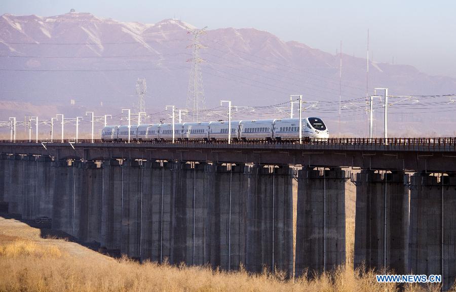 The CRH train D8602 runs to Hami from Urumqi, capital of northwest China's Xinjiang Uygur Autonomous Region, Nov. 16, 2014. 