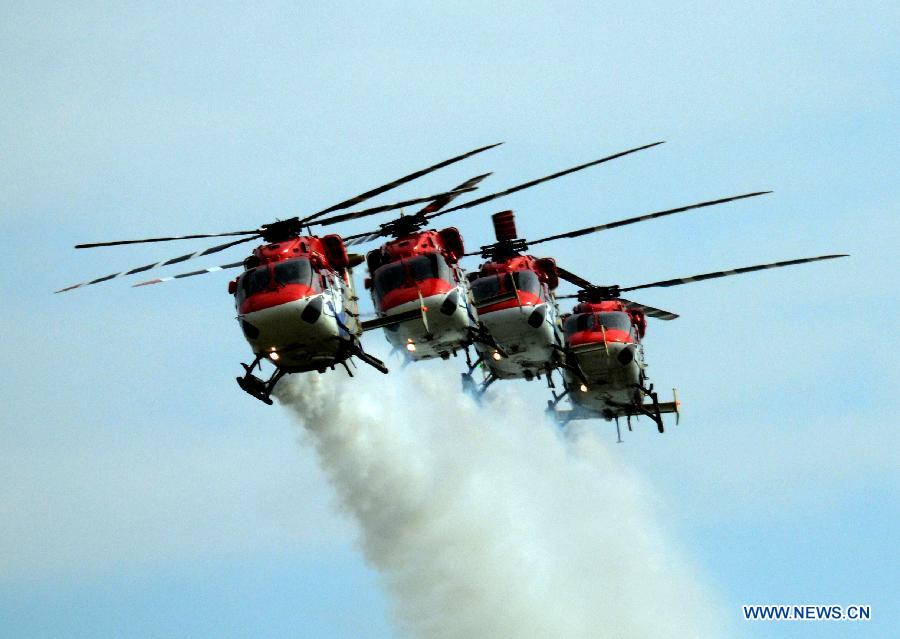 Indian Air Force (IAF) helicopters perform during a parade at an airbase in Tezpur, India, on Nov. 21, 2014.