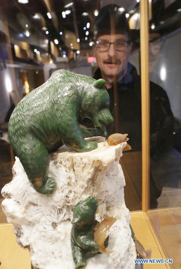 A resident looks at a jade sculpture at the World Jade Symposium in Vancouver, Canada, Nov. 21, 2014. 