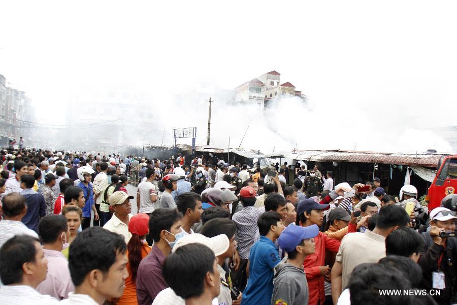 People gather at the site of fire in Phnom Penh, Cambodia, Nov. 24, 2014.