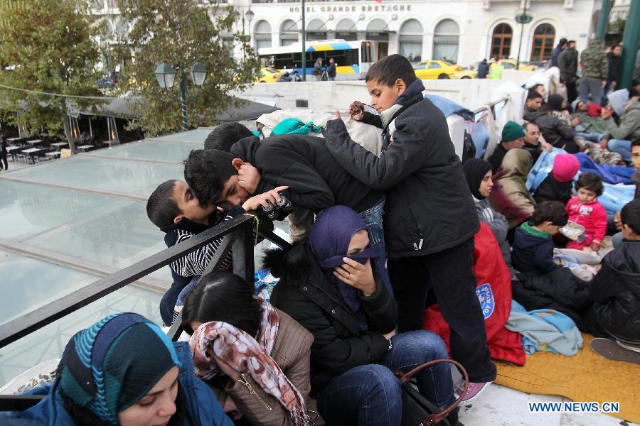 Syrian refugees engage their sixth day of protest in front of Greek parliament in Athens, Nov. 24, 2014.