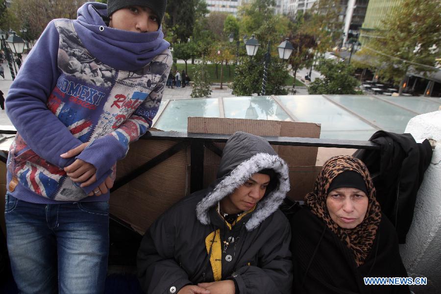 Syrian refugees engage their sixth day of protest in front of Greek parliament in Athens, Nov. 24, 2014. 