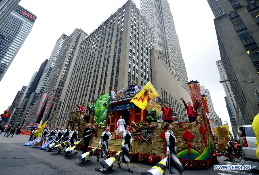 People attend the 88th Macy's Thanksgiving Day Parade in New York, the United States, Nov. 27, 2014.