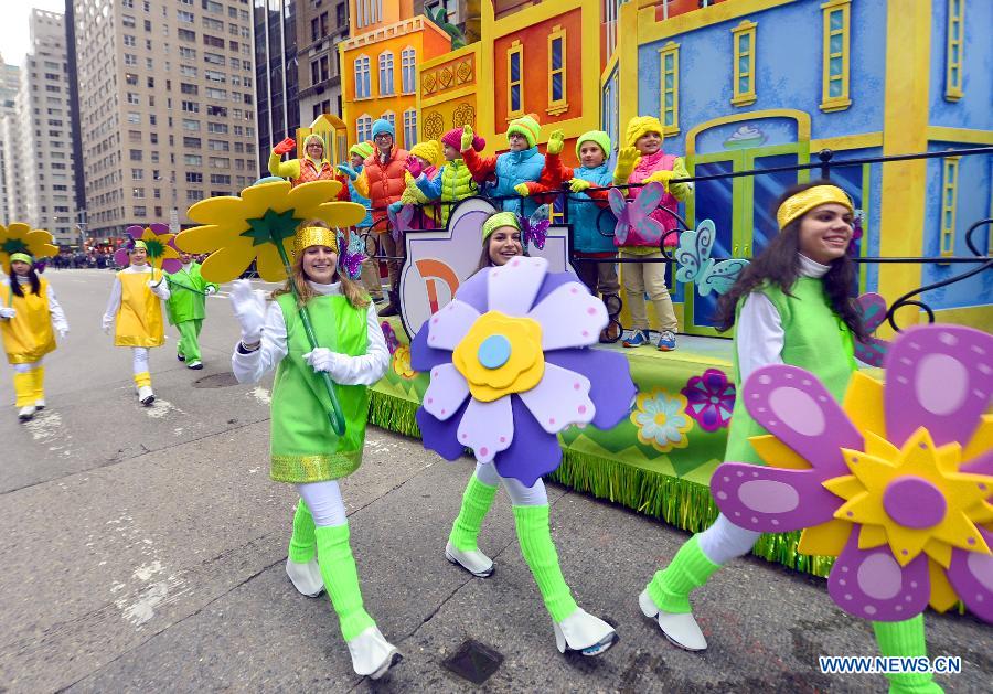 People attend the 88th Macy's Thanksgiving Day Parade in New York, the United States, Nov. 27, 2014. 