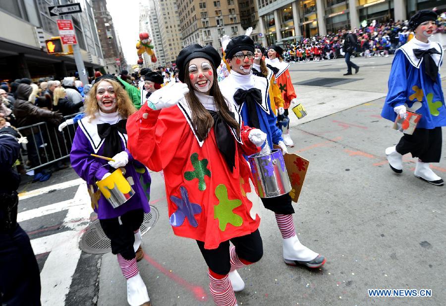 People attend the 88th Macy's Thanksgiving Day Parade in New York, the United States, Nov. 27, 2014.