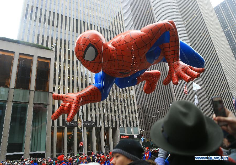 People attend the 88th Macy's Thanksgiving Day Parade in New York, the United States, Nov. 27, 2014.