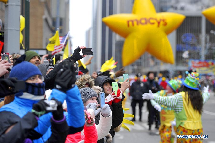 People attend the 88th Macy's Thanksgiving Day Parade in New York, the United States, Nov. 27, 2014.