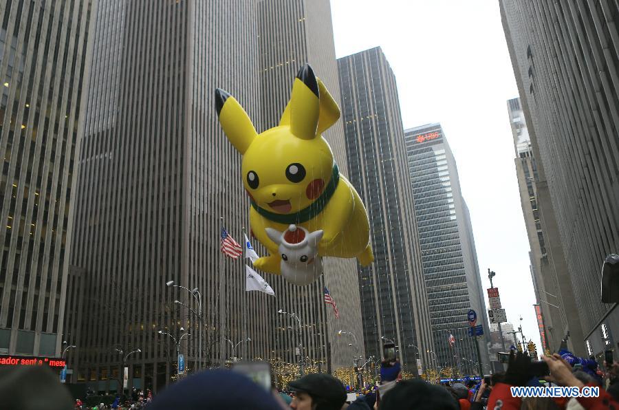 People attend the 88th Macy's Thanksgiving Day Parade in New York, the United States, Nov. 27, 2014.