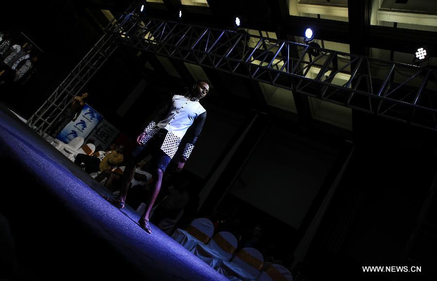 A model presents a fashion creation of designer Lewis Wanyoike during the 2014 Nairobi Fashion Week in Nairobi, capital of Kenya, Nov. 30, 2014.