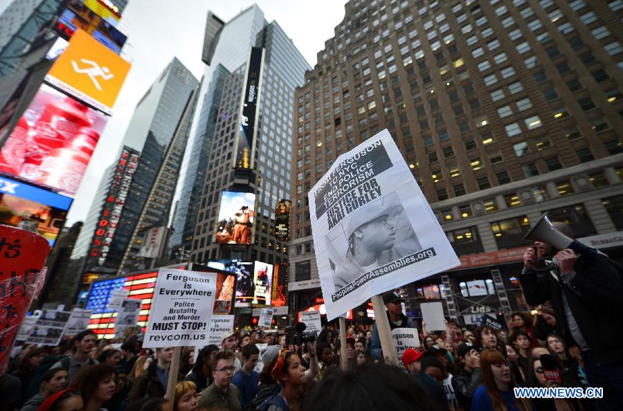 People take part in a protest in New York, the United States, on Dec. 1, 2014.