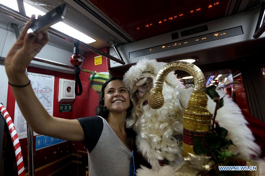 An actor disguised as Santa Claus travels in a wagon of the Sao Paulo Metro Yellow Line, in the city of Sao Paulo, Brazil, on Dec. 1, 2014.