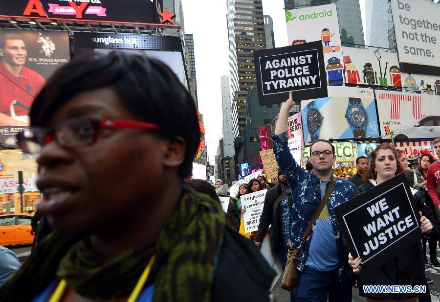 People take part in a protest in New York, the United States, on Dec. 1, 2014.