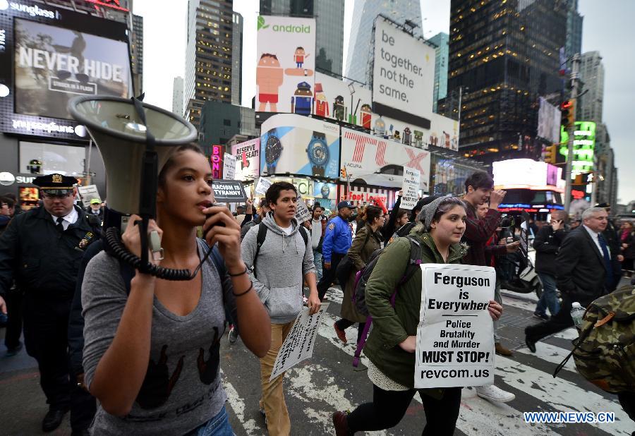 People take part in a protest in New York, the United States, on Dec. 1, 2014.