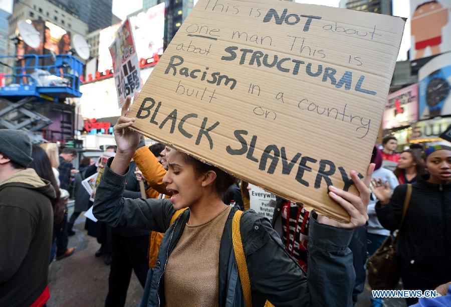 People take part in a protest in New York, the United States, on Dec. 1, 2014.