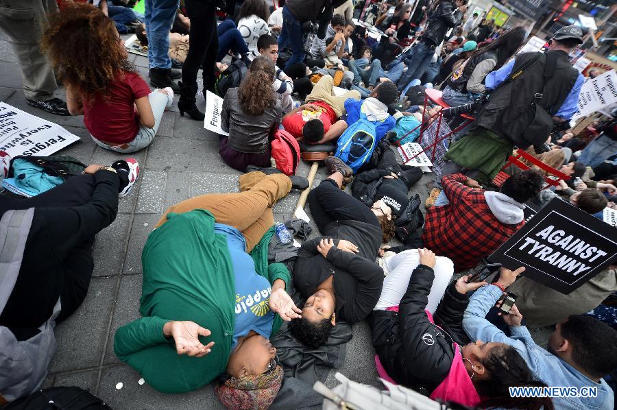 People take part in a protest in New York, the United States, on Dec. 1, 2014.