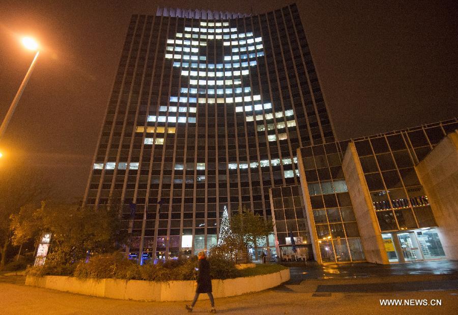 Zagrepcanka office building is illuminated with the image of red ribbon in Zagreb, Croatia, Dec. 1, 2014. 