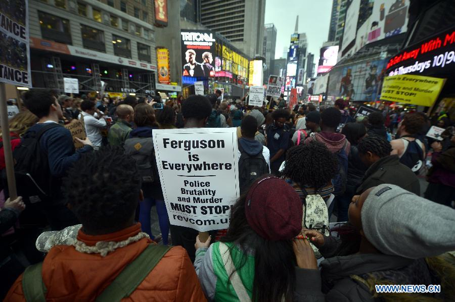 People take part in a protest in New York, the United States, on Dec. 1, 2014.