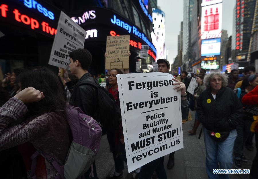 People take part in a protest in New York, the United States, on Dec. 1, 2014.