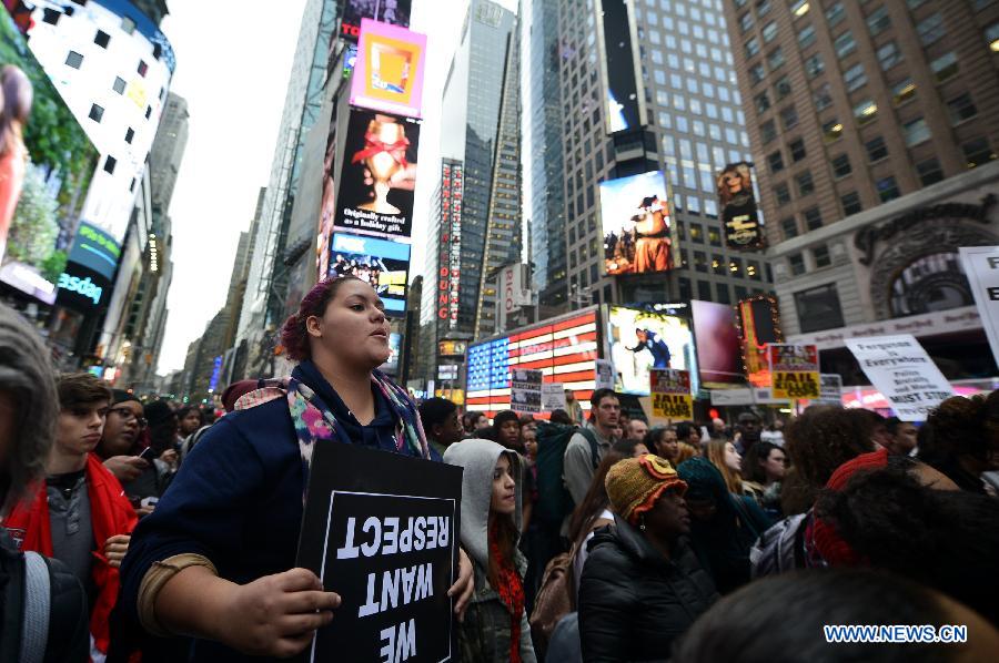 People take part in a protest in New York, the United States, on Dec. 1, 2014.