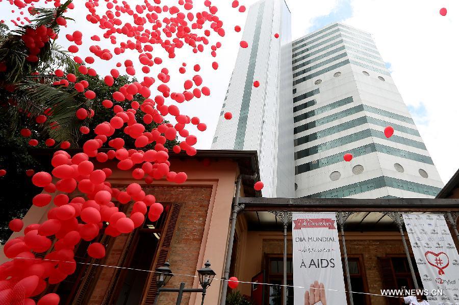 Residents participate in a meeting to commemorate the 'World AIDS Day', held in the Revolution Monument, in Mexico City, capital of Mexico, on Dec. 1, 2014. 