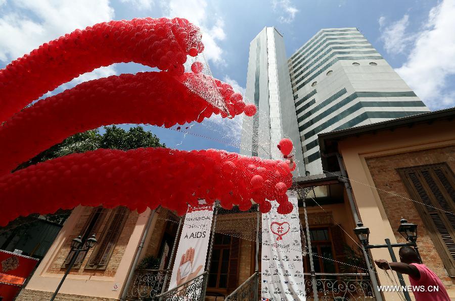 Residents participate in a meeting to commemorate the 'World AIDS Day', held in the Revolution Monument, in Mexico City, capital of Mexico, on Dec. 1, 2014. 