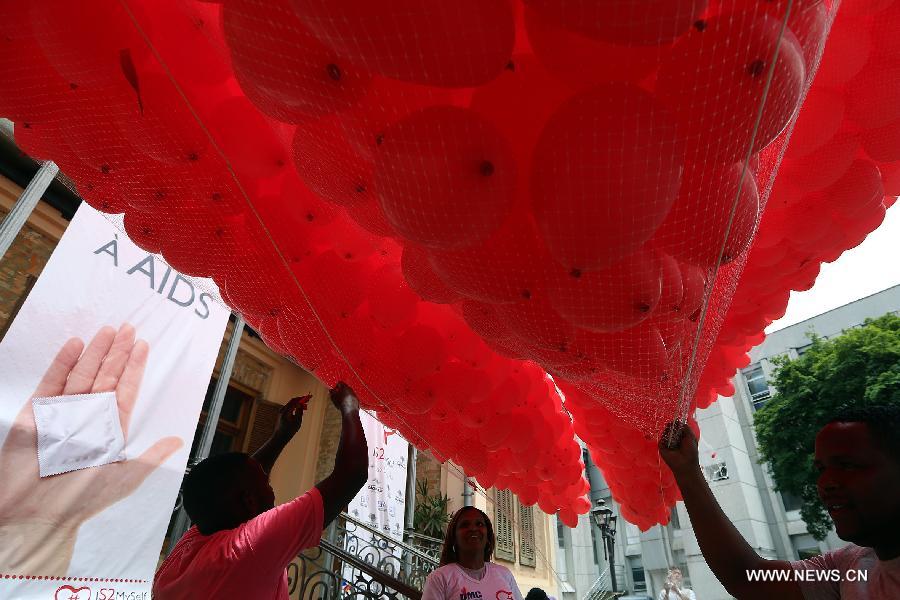 Residents participate in a meeting to commemorate the 'World AIDS Day', held in the Revolution Monument, in Mexico City, capital of Mexico, on Dec. 1, 2014. 