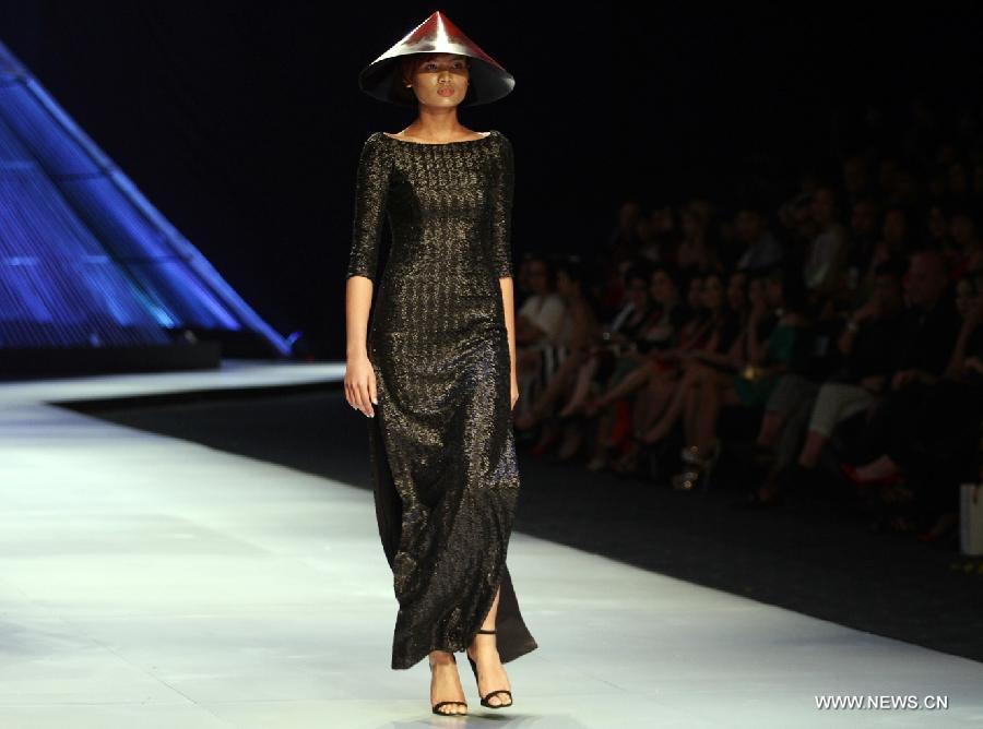 A model presents a creation of Vietnamese designer Hoang Minh Ha during the Vietnam International Fashion Week 2014 in Ho Chi Minh city, Vietnam, Dec. 4, 2014.