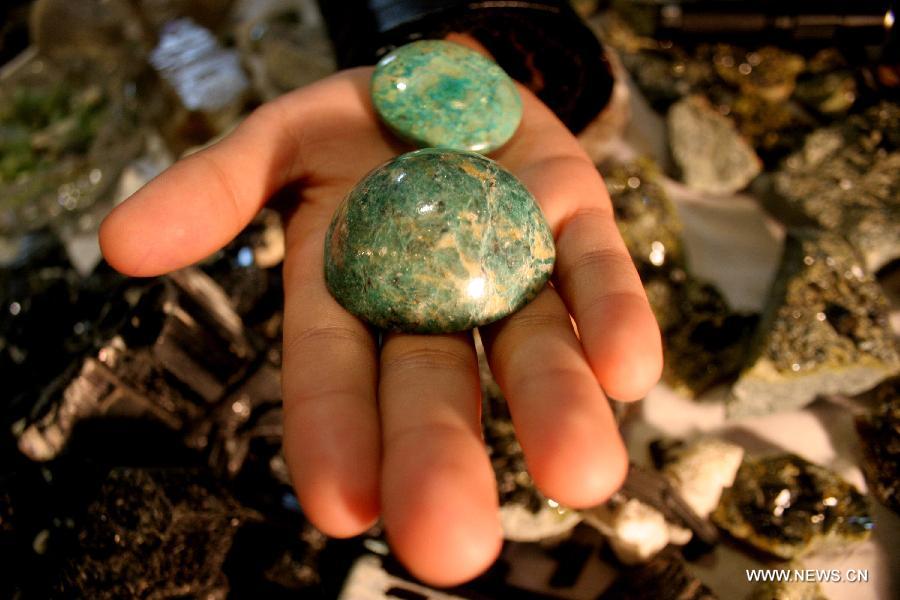 A vendor shows Turquoises from Afghanistan at a gems stall on the last day of Gems and Jewellery Exhibition in northwest Pakistan's Peshawar on Dec. 7, 2014.