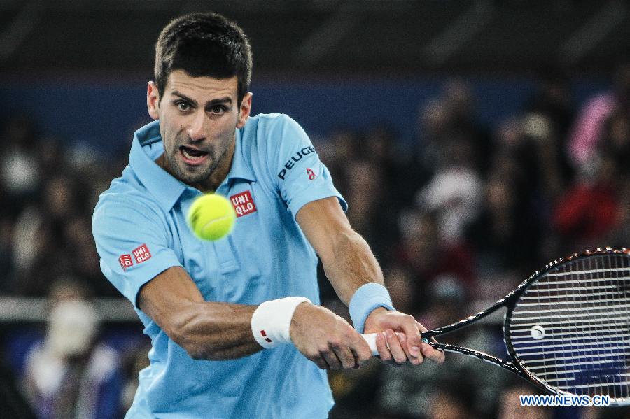 Novak Djokovic of UAE Royals returns a ball during the match against Roger Federer of Indian Aces at the Indian Leg of the International Premier Tennis League in New Delhi, India, Dec. 8, 2014. UAE Royals won 29-22. (Xinhua/Zheng Huansong) 