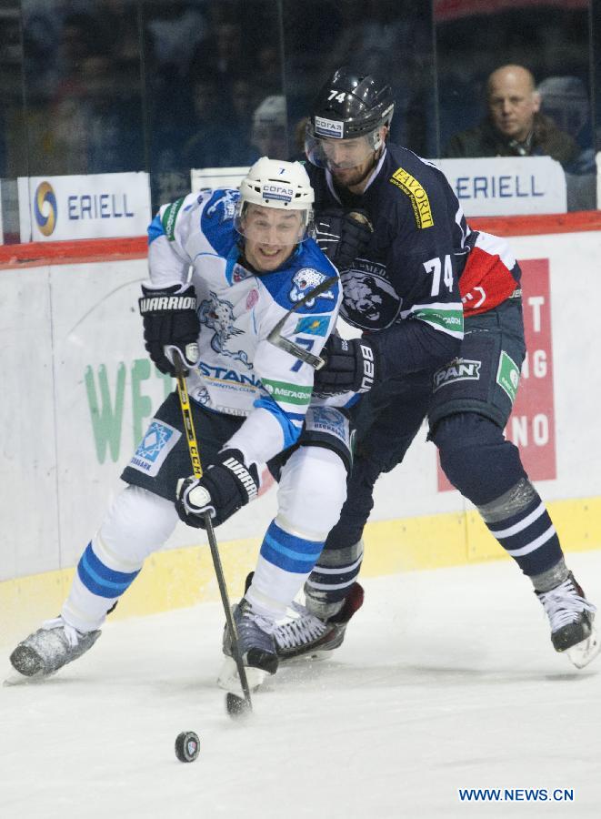 Maxim Semyonov (L) of Barys Astana vies with Nathan Perkovich of Medvescak Zagreb during a match at Kontinental Hockey League (KHL) in Zagreb, capital of Croatia, Dec. 8, 2014. Barys Astana won 5-3. (Xinhua/Miso Lisanin) 