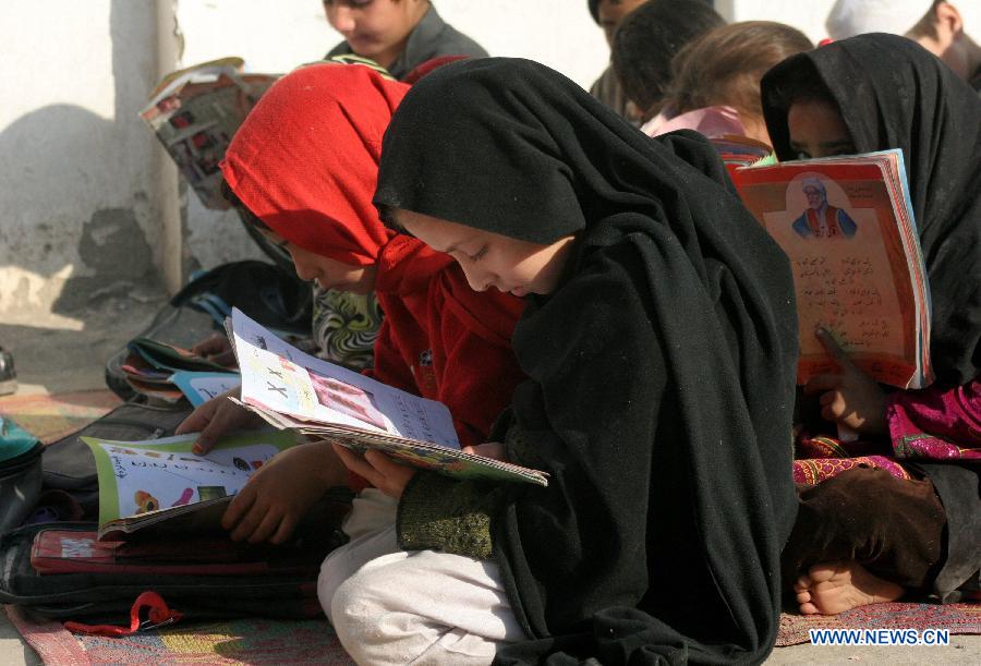 Girls attend a class at a government school in northwest Pakistan's Peshawar, Dec. 11, 2014.