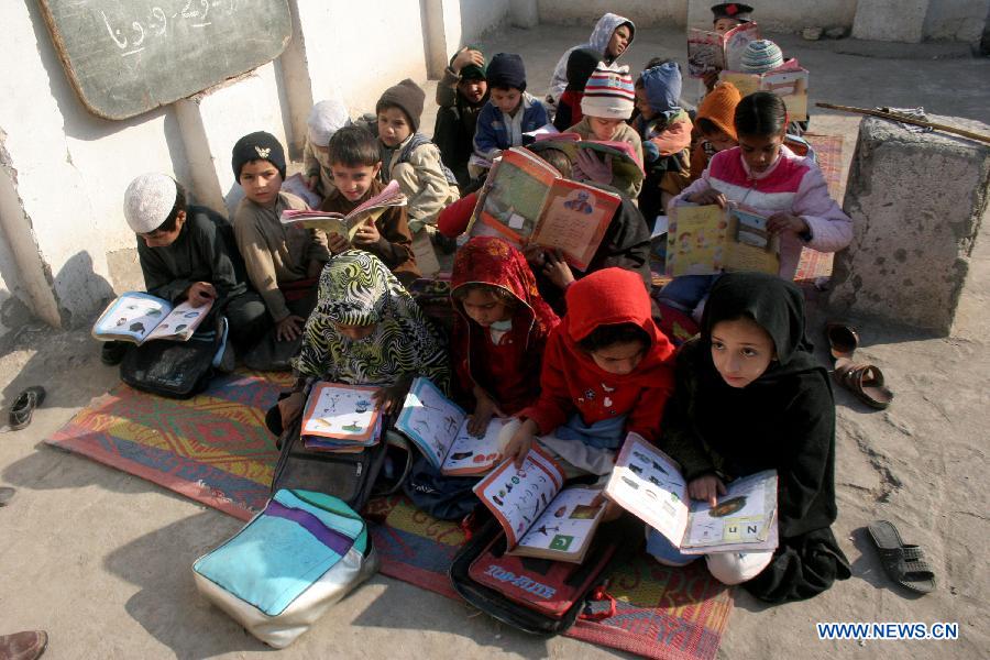 Children attend a class at a government school in northwest Pakistan's Peshawar, Dec. 11, 2014.