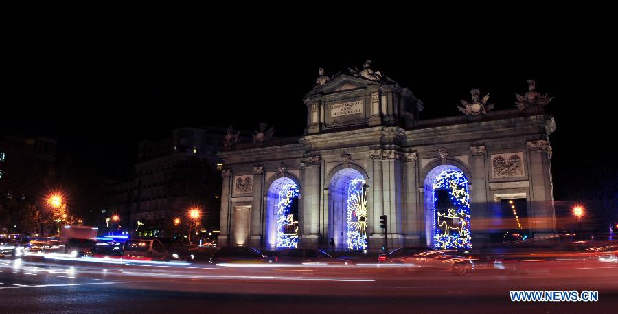 Famous landmark Alcala Gate is illuminated with lights for Christmas in Madrid, Spain on Dec. 11, 2014.