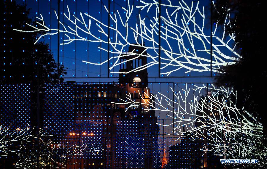 A street is illuminated with lights for Christmas in Madrid, Spain on Dec. 11, 2014.