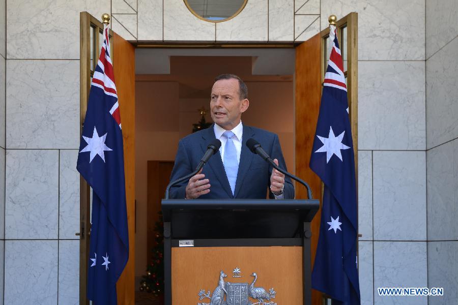 Australian Prime Minister Tony Abbott delivers a short speech at a press conference in the Parliament House hours after a few gunmen took people hostage in a cafe in Sydney CBD, in Canberra, Australia, Dec. 15, 2014.