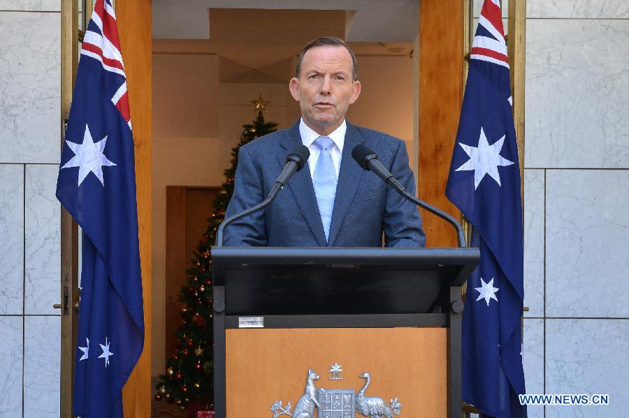 Australian Prime Minister Tony Abbott delivers a short speech at a press conference in the Parliament House hours after a few gunmen took people hostage in a cafe in Sydney CBD, in Canberra, Australia, Dec. 15, 2014.