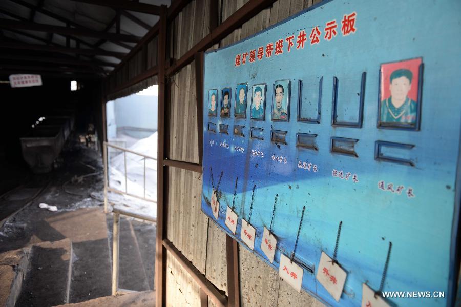 Photo taken on Dec. 15, 2014 shows a billboard at the portal of a coal mine in which explosion occurred at the Xingyun Colliery in Jixi City, northeast China's Heilongjiang Province. Ten people trapped underground after the gas explosion at Xingyun Colliery have died, according to a statement from the provincial production safety supervision and administration bureau. The explosion occurred at 10:10 a.m. on Sunday. The cause of the accident is being investigated. (Xinhua/Wang Kai)