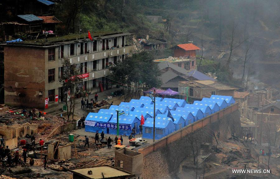 Photo taken on Dec. 14, 2014 shows the makeshift rents in Jiuji Village of Jianhe County, southwest China's Guizhou Province. A fire engulfed the Jiuji Village at around 3:40 p.m. on Saturday, affecting 619 residents. The relief work is underway. Jiuji is one of the biggest and best preserved villages of the Miao ethnic minority. It was selected by China as a UNESCO World Heritage site nominee in 2006. (Xinhua/Peng Wengui)