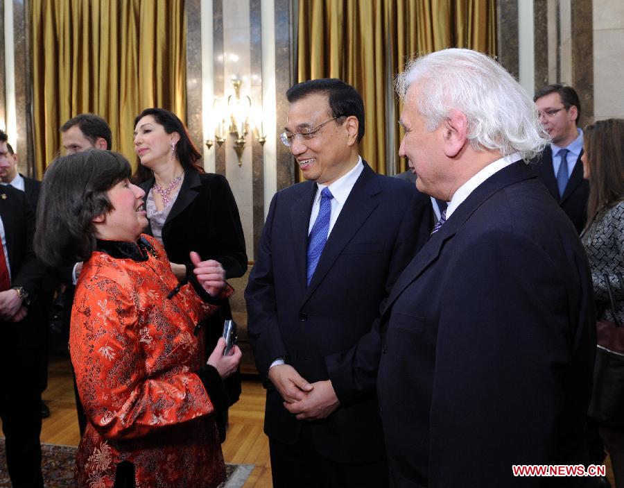 Chinese Premier Li Keqiang (C) talks with Sinologists Mr. and Mrs. Pop-Cenic in Belgrade, Serbia, Dec. 18, 2014. Li was presented the charter of honorary citizen of Belgrade on Thursday afternoon and exchanged views with some distinguished Serbian personages on expanding bilateral cooperation in such areas as culture and sports. (Xinhua/Rao Aimin)