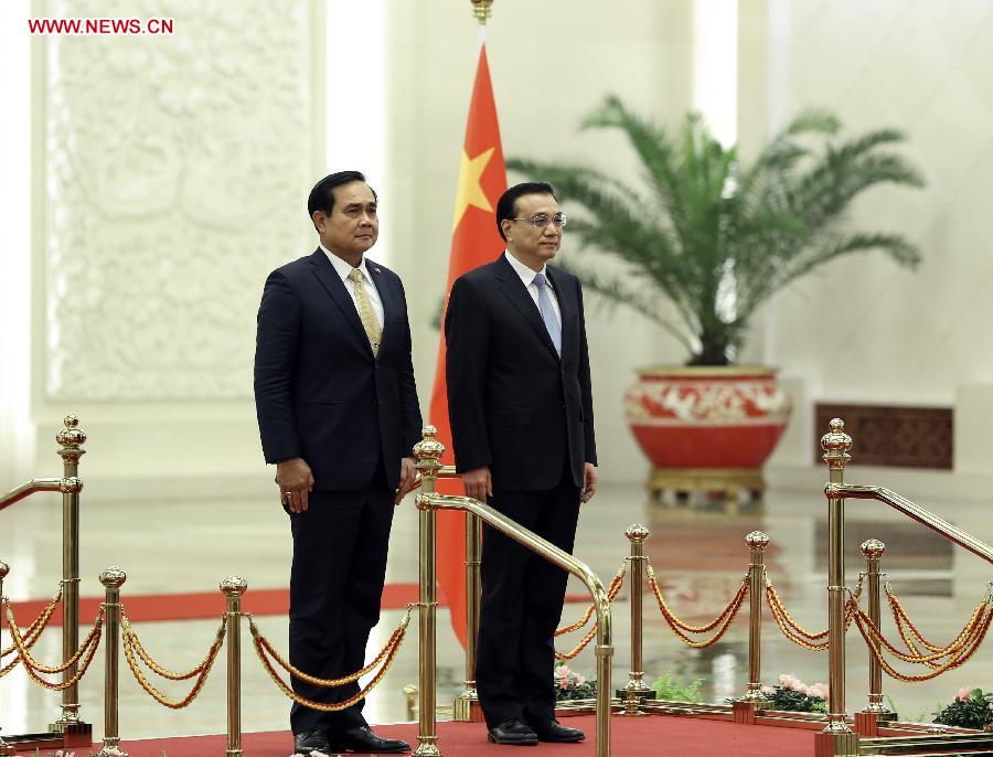 Chinese Premier Li Keqiang (R) shakes hands with visiting Thai Prime Minister Prayuth Chan-ocha before their talks in Beijing, capital of China, Dec. 22, 2014. 