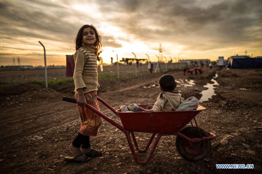 A girl plays inside a refugee camp in Erbil, capital of Iraq's Kurdish autonomous region, Dec. 12, 2014. 