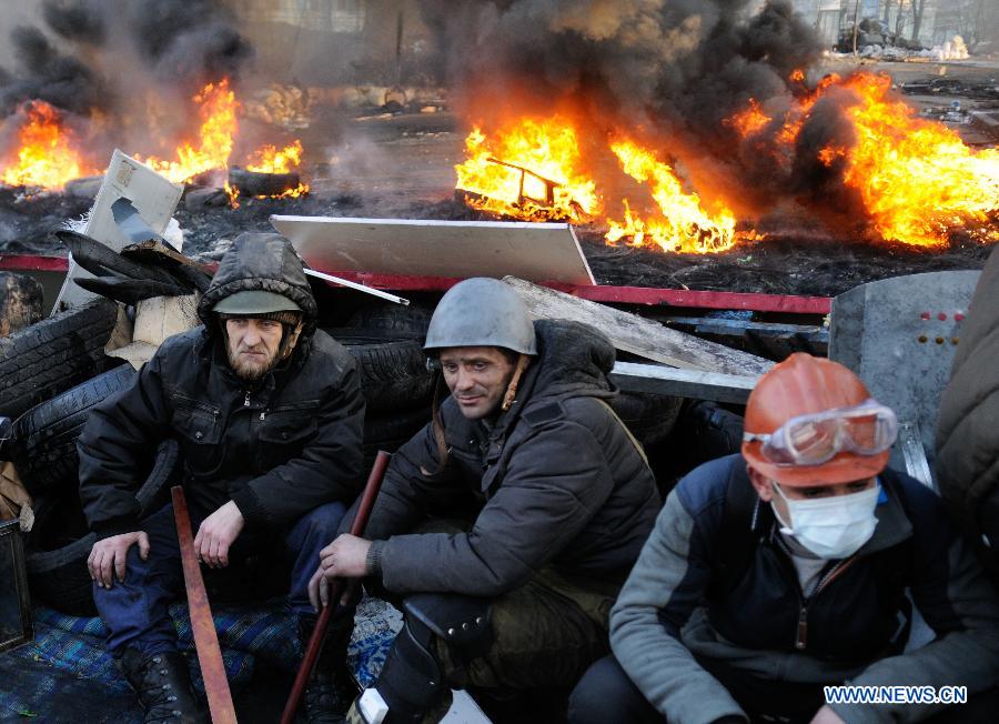 Protestors rest after clashes with police near the Independence Square in Kiev, Ukraine, Feb. 20, 2014.