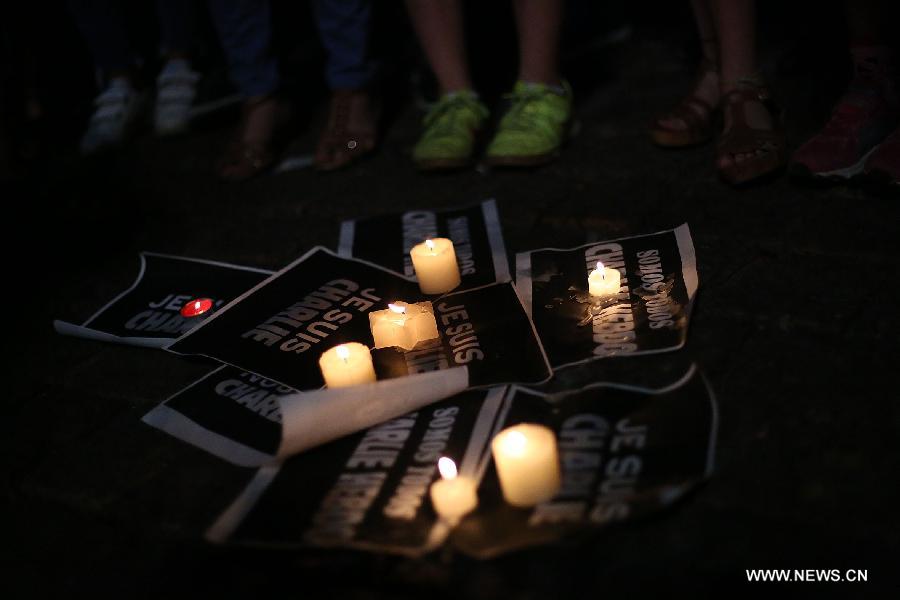 People take part in a gathering mourning the people killed in an attack at the Paris offices of weekly newspaper 'Charlie Hebdo', in Sao Paulo, Brazil, on Jan. 7, 2015.