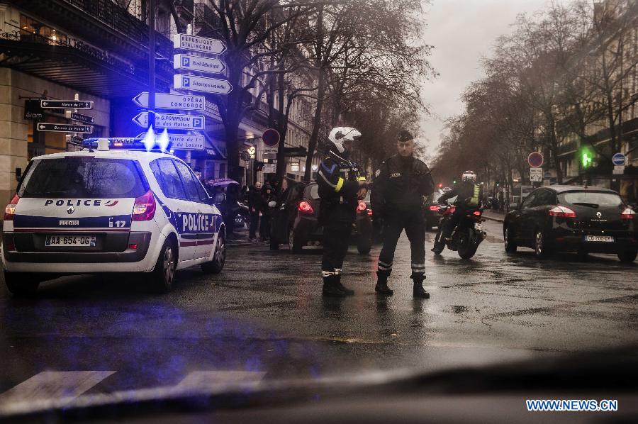 Police patrol along a main street in Paris, France, Jan. 8, 2015. Paris has been beefing up security in precaution after Wednesday's deadly attack which left 12 people killed and 11 others injured.