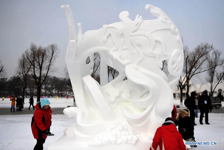 Sculptors of Mongolia work on a snow sculpture at the 20th Harbin International Snow Sculpture Contest in Harbin, capital of northeast China's Heilongjiang Province, Jan. 13, 2015.