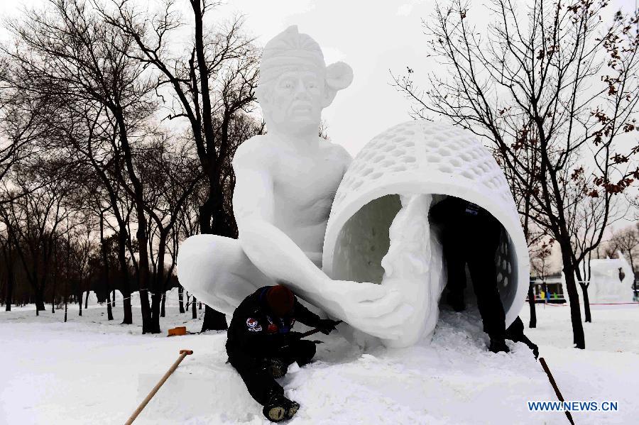 Indonesian sculptors work on a snow sculpture at the 20th Harbin International Snow Sculpture Contest in Harbin, capital of northeast China's Heilongjiang Province, Jan. 13, 2015. 