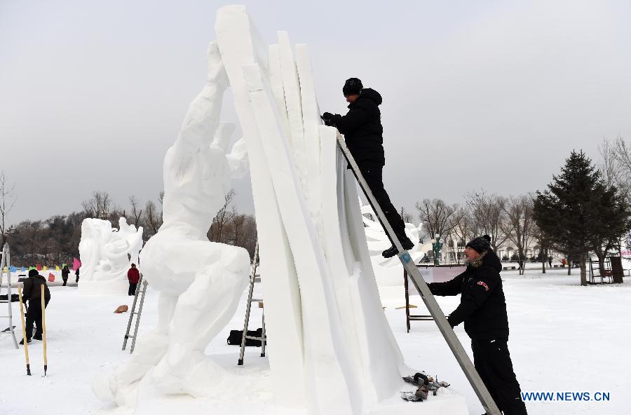 Polish sculptors work on a snow sculpture at the 20th Harbin International Snow Sculpture Contest in Harbin, capital of northeast China's Heilongjiang Province, Jan. 13, 2015.