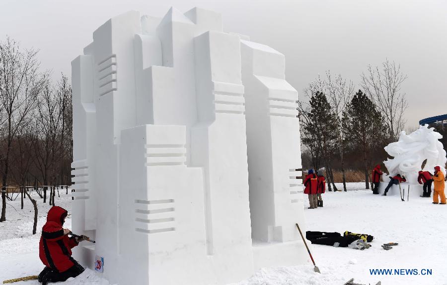 A Russian sculptor works on a snow sculpture at the 20th Harbin International Snow Sculpture Contest in Harbin, capital of northeast China's Heilongjiang Province, Jan. 13, 2015. 