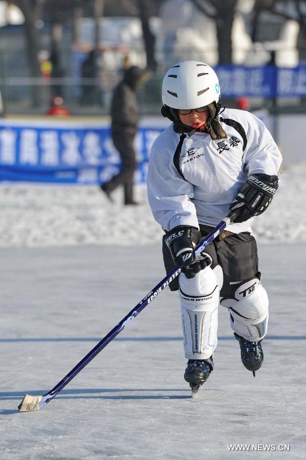 A boy practices ice hockey at an ice rink inside the Nanhu Park in Changchun, capital of northeast China's Jilin Province, Jan. 17, 2015.